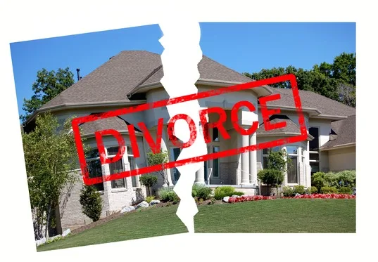 A large house split in half with the word “DIVORCE” stamped in red across the image, symbolizing separation of property.