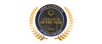 A gold and blue badge reading “American Institute of Trial Lawyers Litigator of the Year 2023” with laurel leaves on both sides.