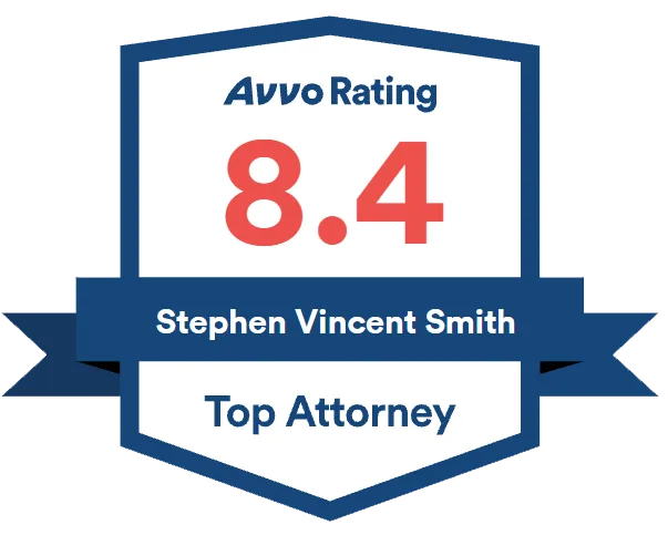 Avvo rating badge showing a score of 8.4 for Stephen Vincent Smith with the title “Top Attorney” in a blue and white shield design.